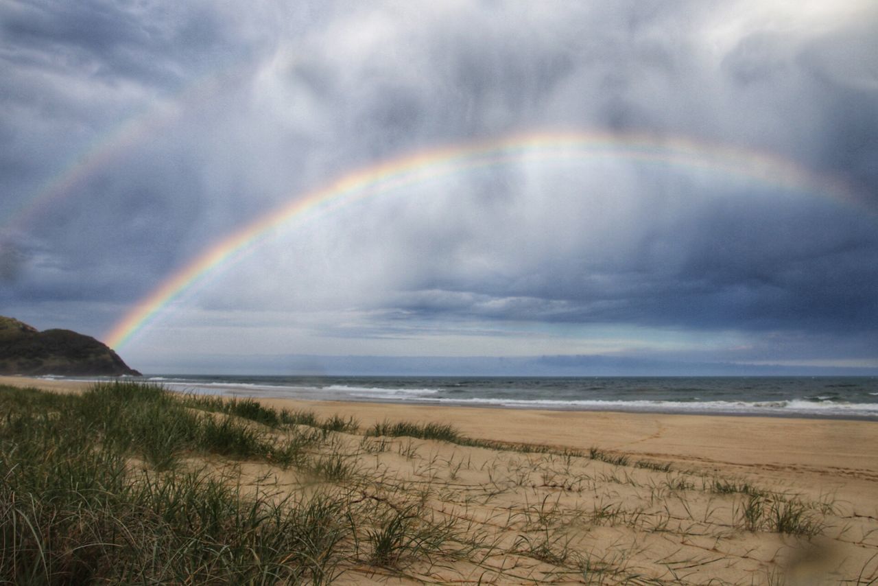 SCENIC VIEW OF RAINBOW OVER BEACH