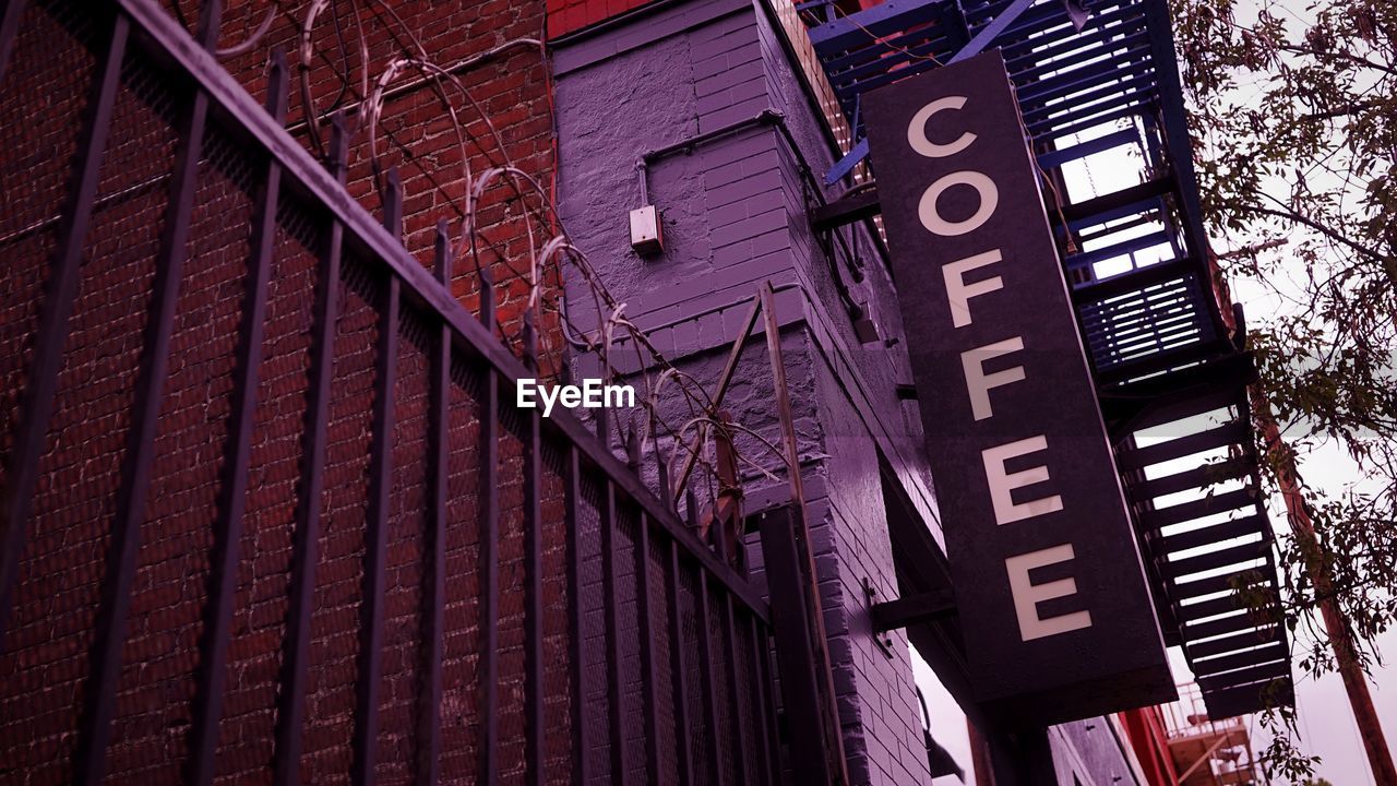 Low angle view of coffee sign on building