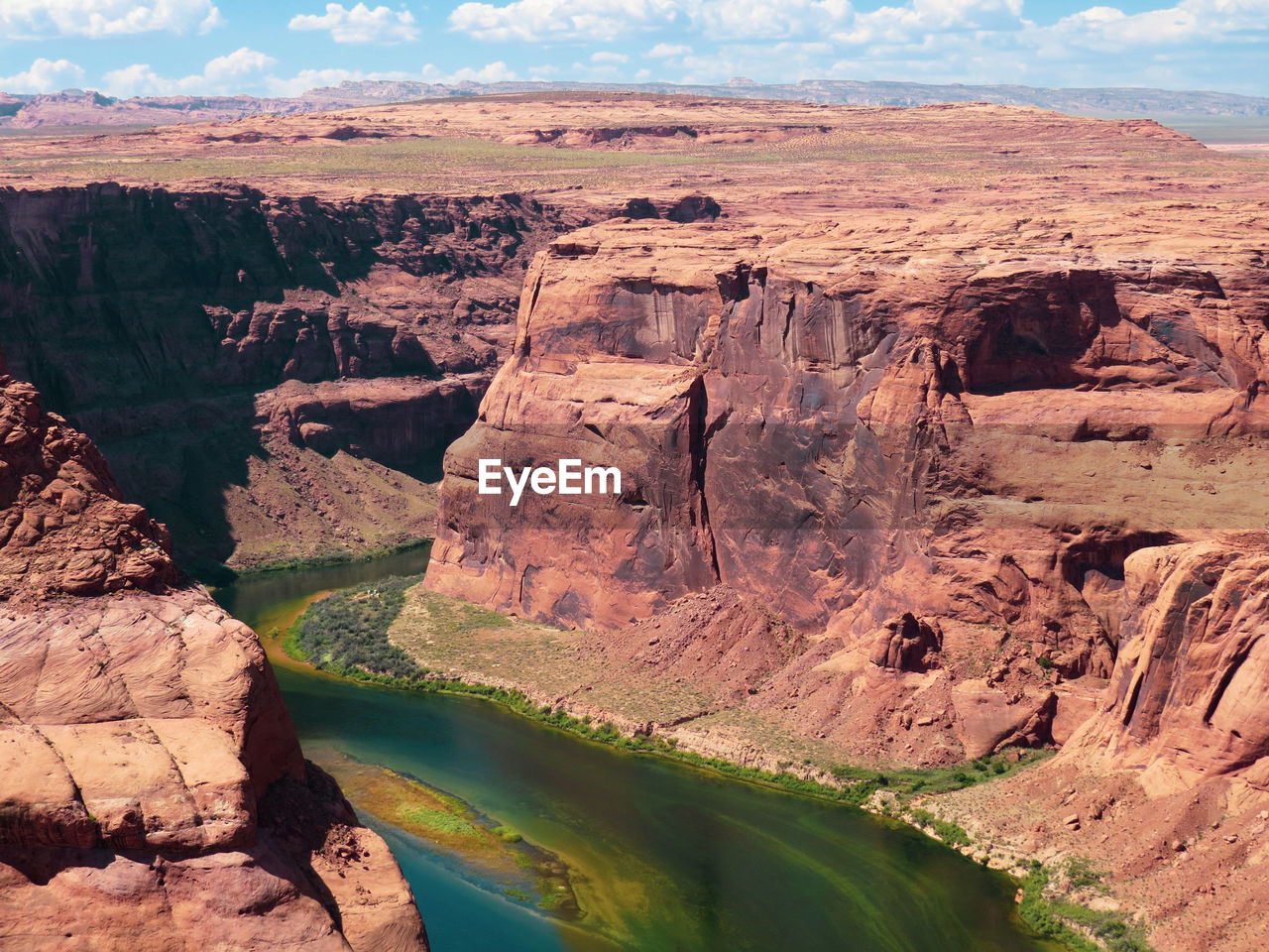 SCENIC VIEW OF ROCKS IN RIVER AGAINST SKY