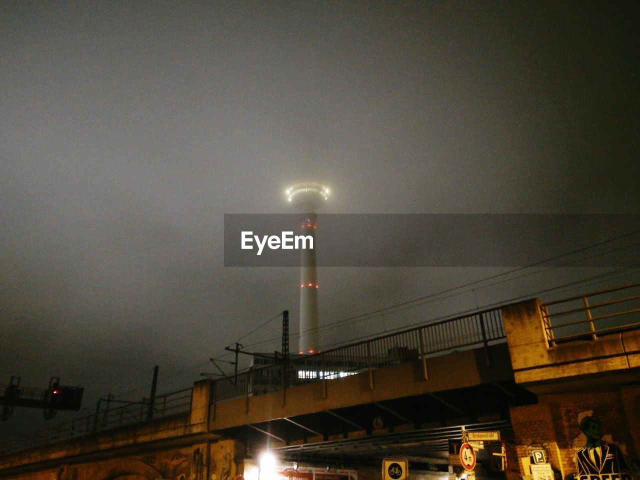 ILLUMINATED FACTORY AGAINST SKY