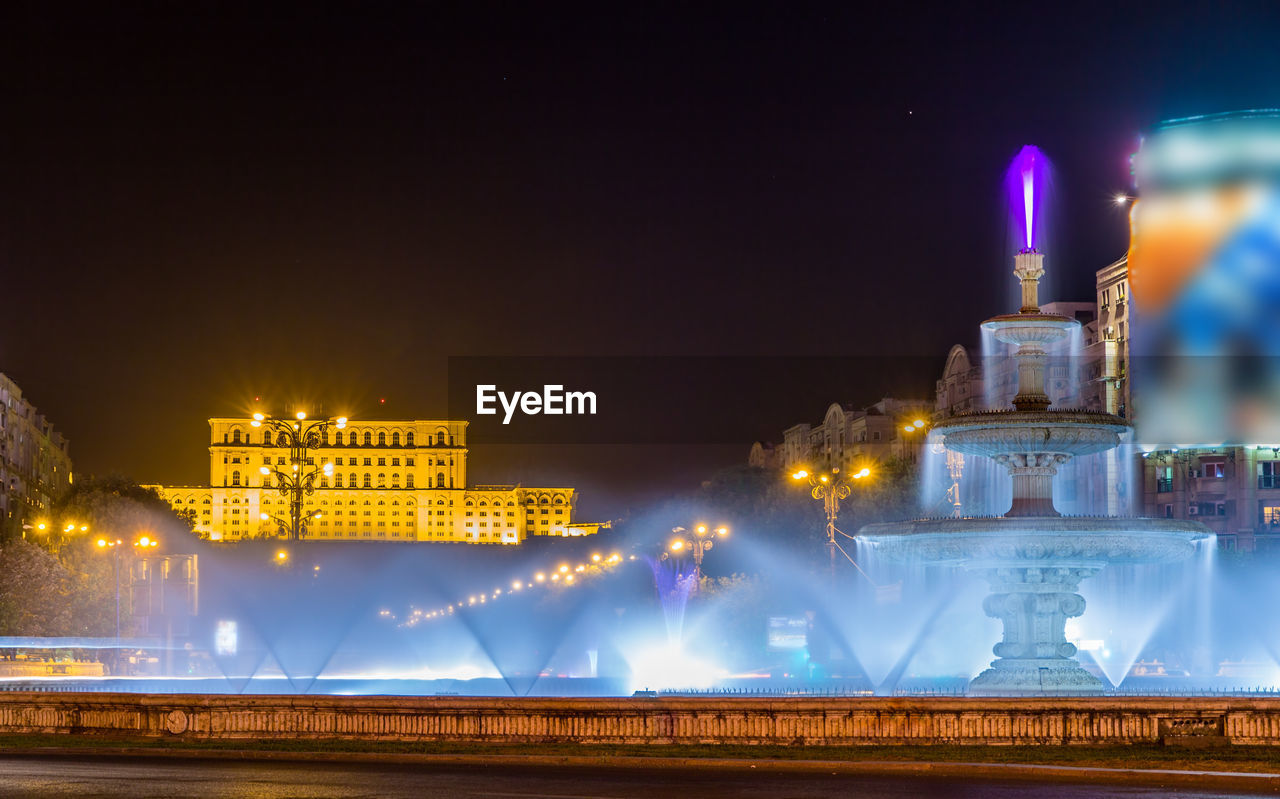 ILLUMINATED BUILDING AGAINST SKY AT NIGHT