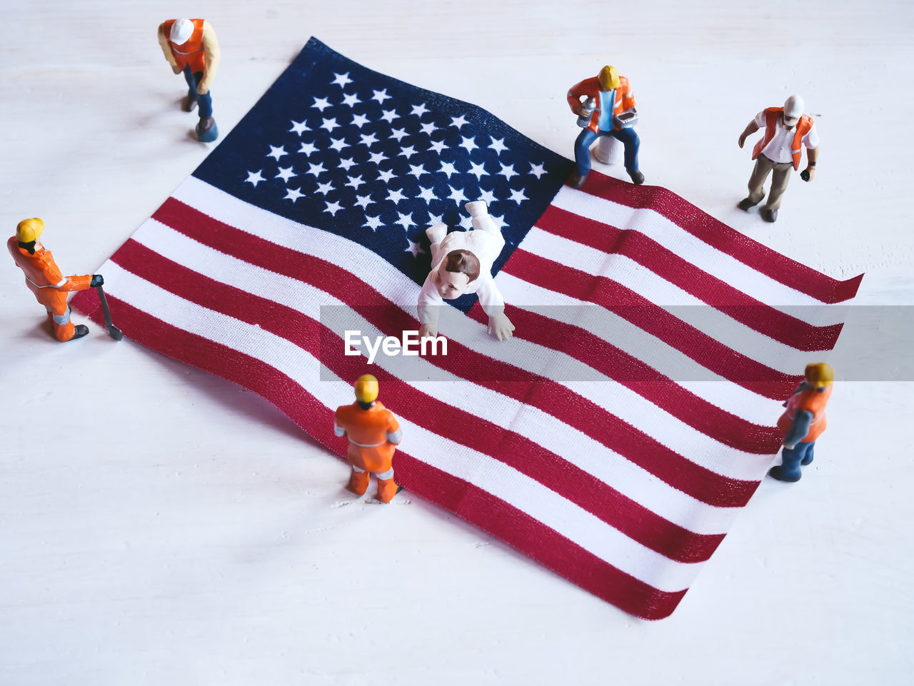 HIGH ANGLE VIEW OF PEOPLE STANDING ON SNOW COVERED FLAG