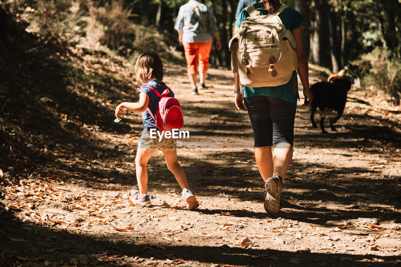 Mother and daughter hiking in forest