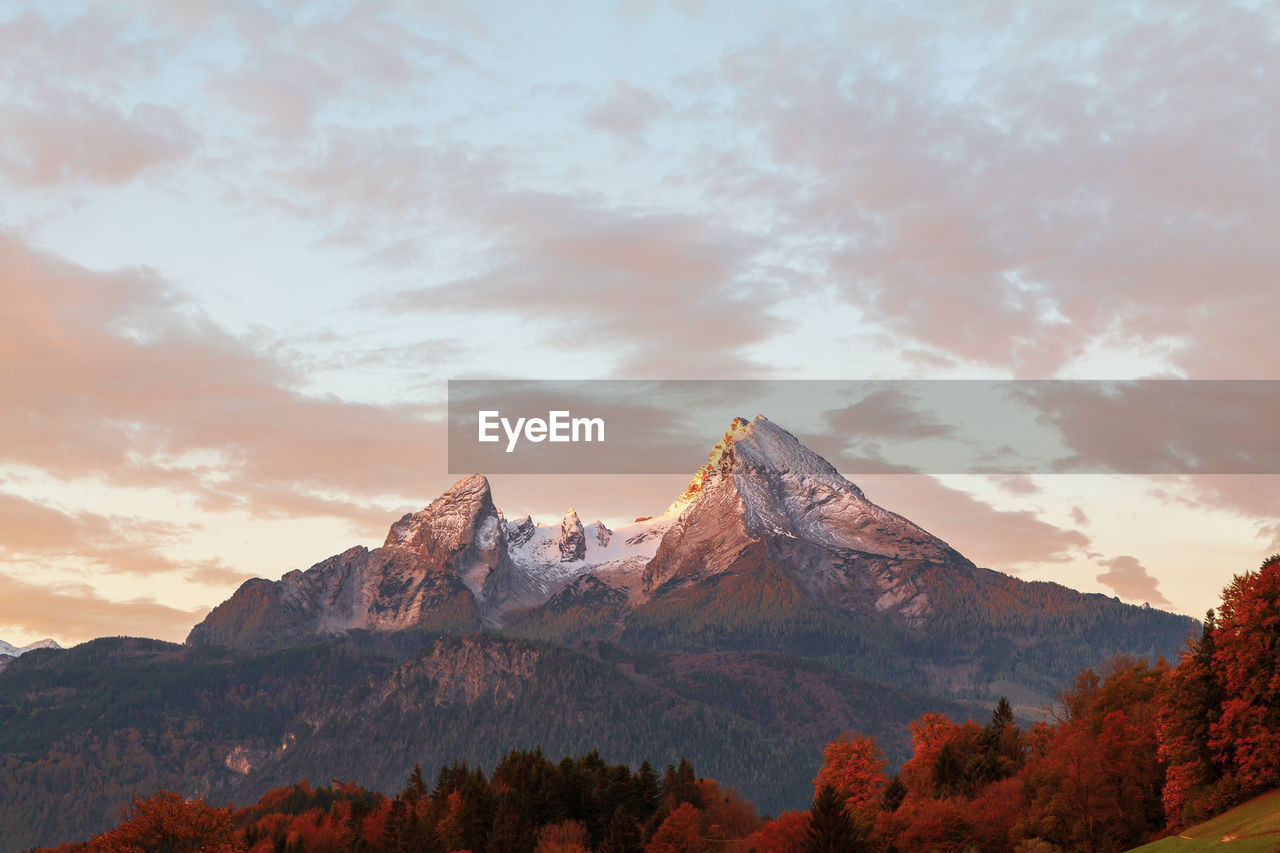 Scenic view of snowcapped mountains against sky during sunset