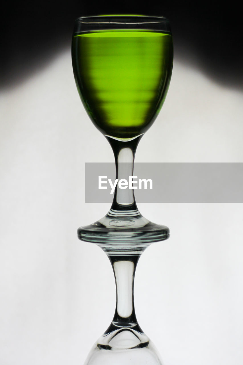 Close-up of wineglass against white background, marjan melon