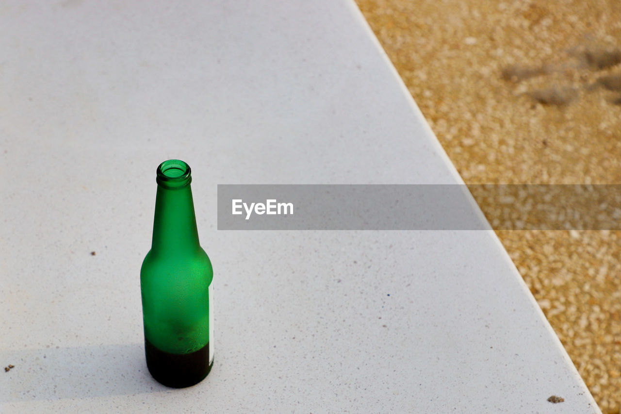 Beer Beer Bottle Alcohol Alcoholic Drink Beach Bottle Close-up Container Focus On Foreground Glass - Material Green Green Color High Angle View Indoors  Land Nature No People Plastic Single Object Still Life Table Water