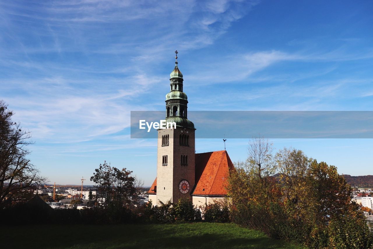 Church on field against blue sky