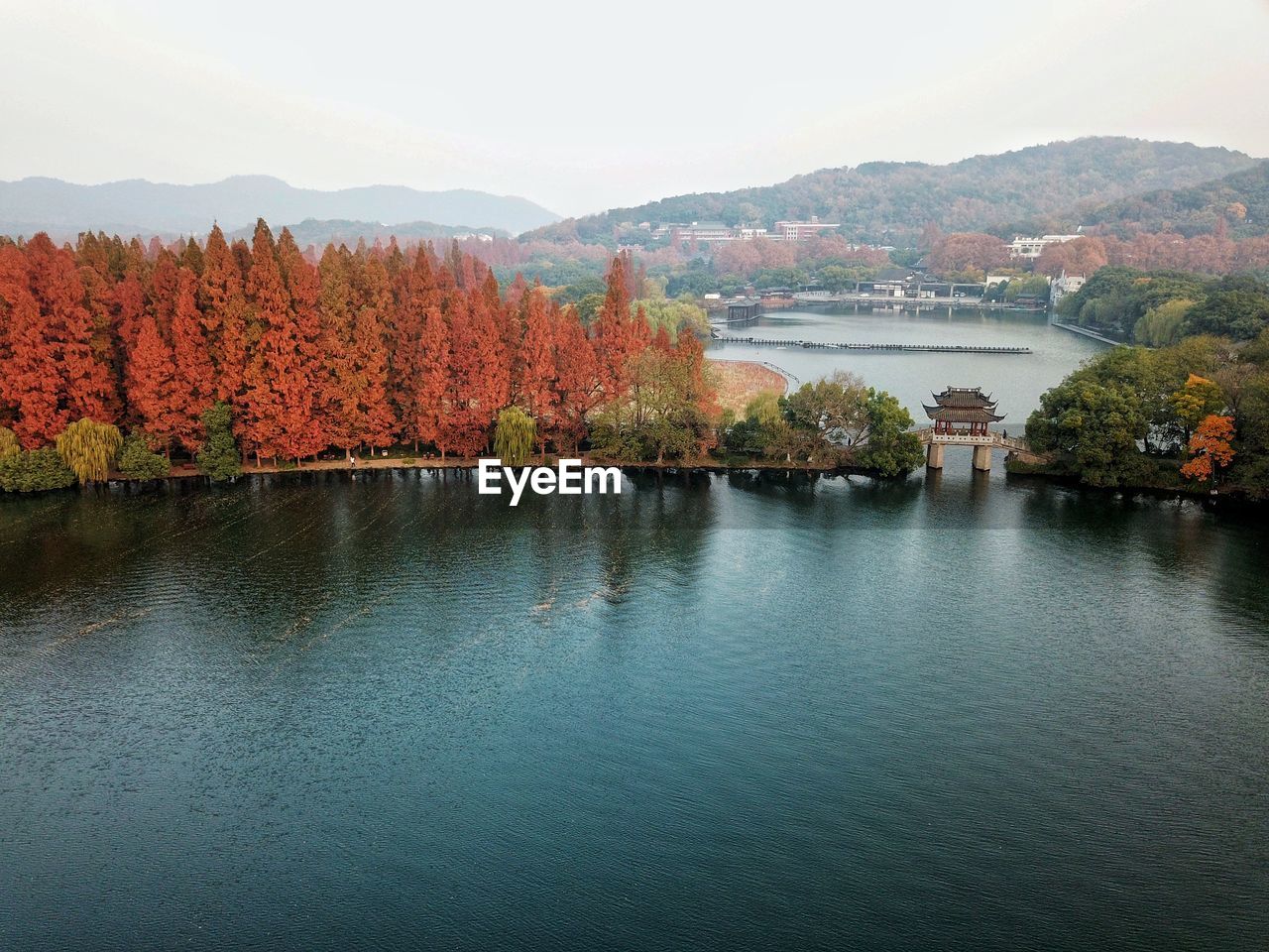 Scenic view of river by trees against sky during autumn