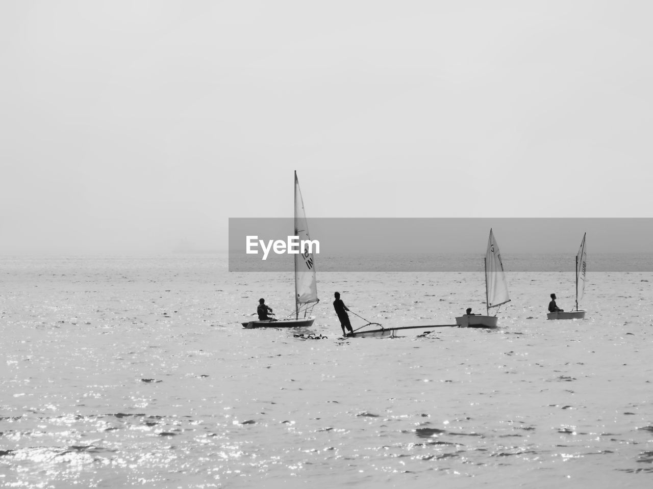 PEOPLE ON SEA AGAINST SKY