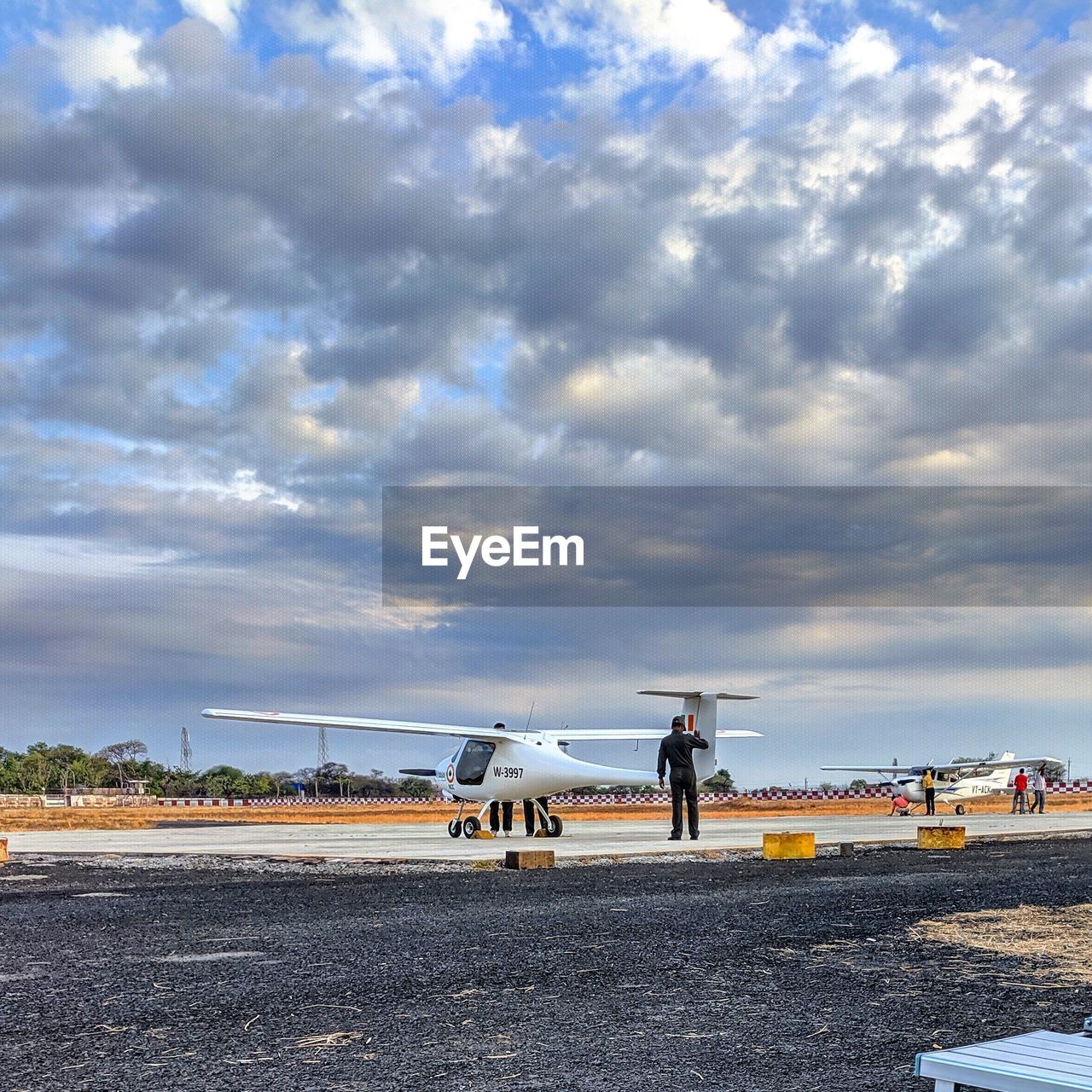 PEOPLE ON RUNWAY AGAINST SKY