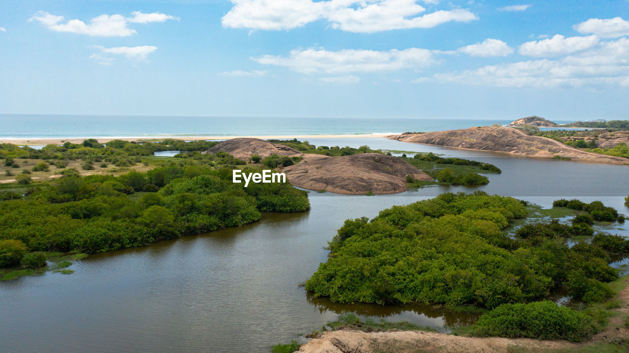 A lake with tropical vegetation and a coastline with a beach. arugam bay, sri lanka.
