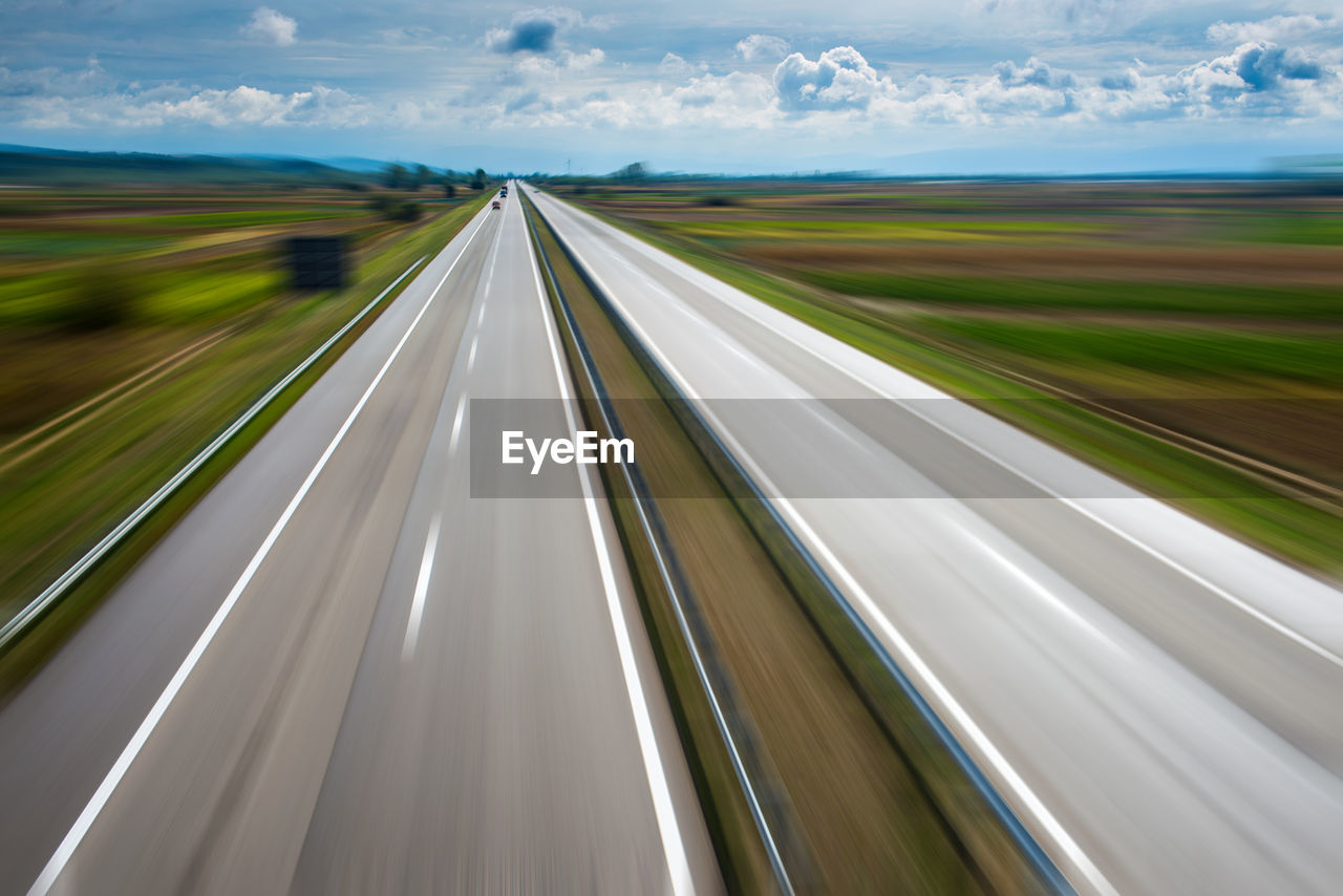 Blurred motion of highway against sky