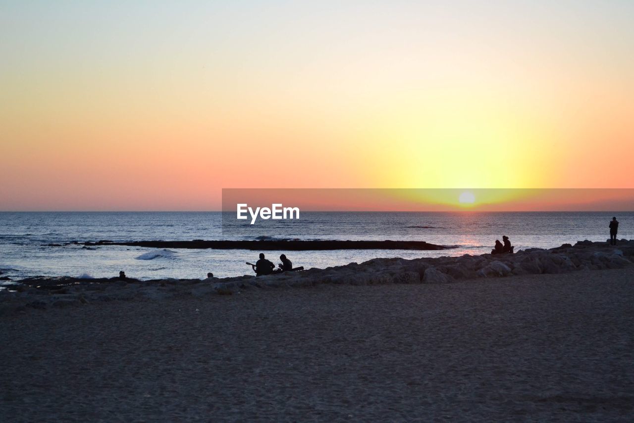 SCENIC VIEW OF SEA AGAINST ORANGE SKY