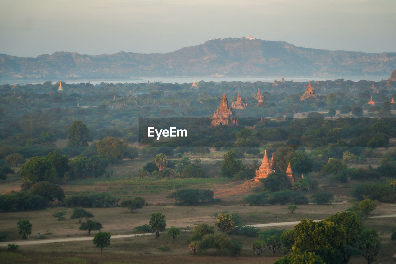 Panoramic view of pagodas in green fields in bagan