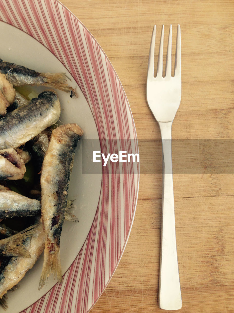 High angle view of anchovy fishes on table