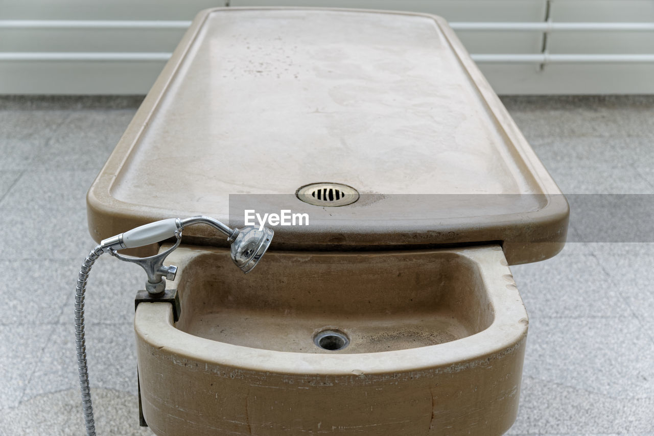 High angle view of antique autopsy table