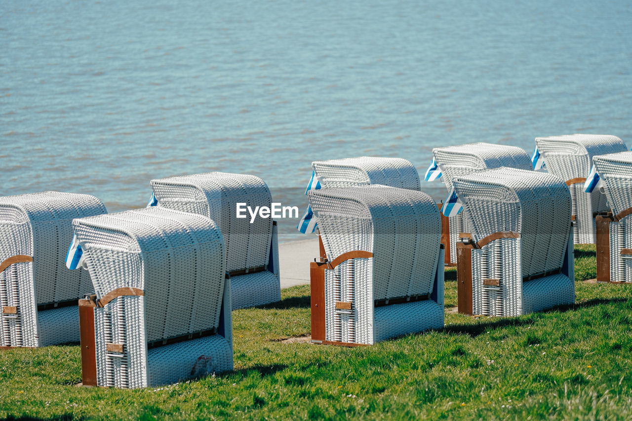 Wicker beach chair in a row at the sea