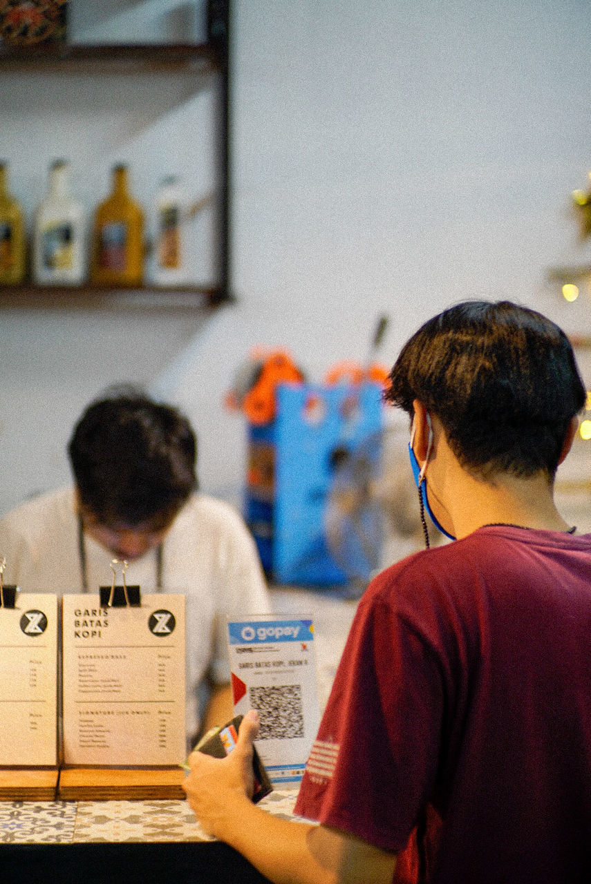 REAR VIEW OF TWO BOYS AT HOME