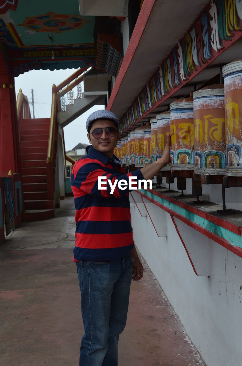 Portrait of young man standing in temple