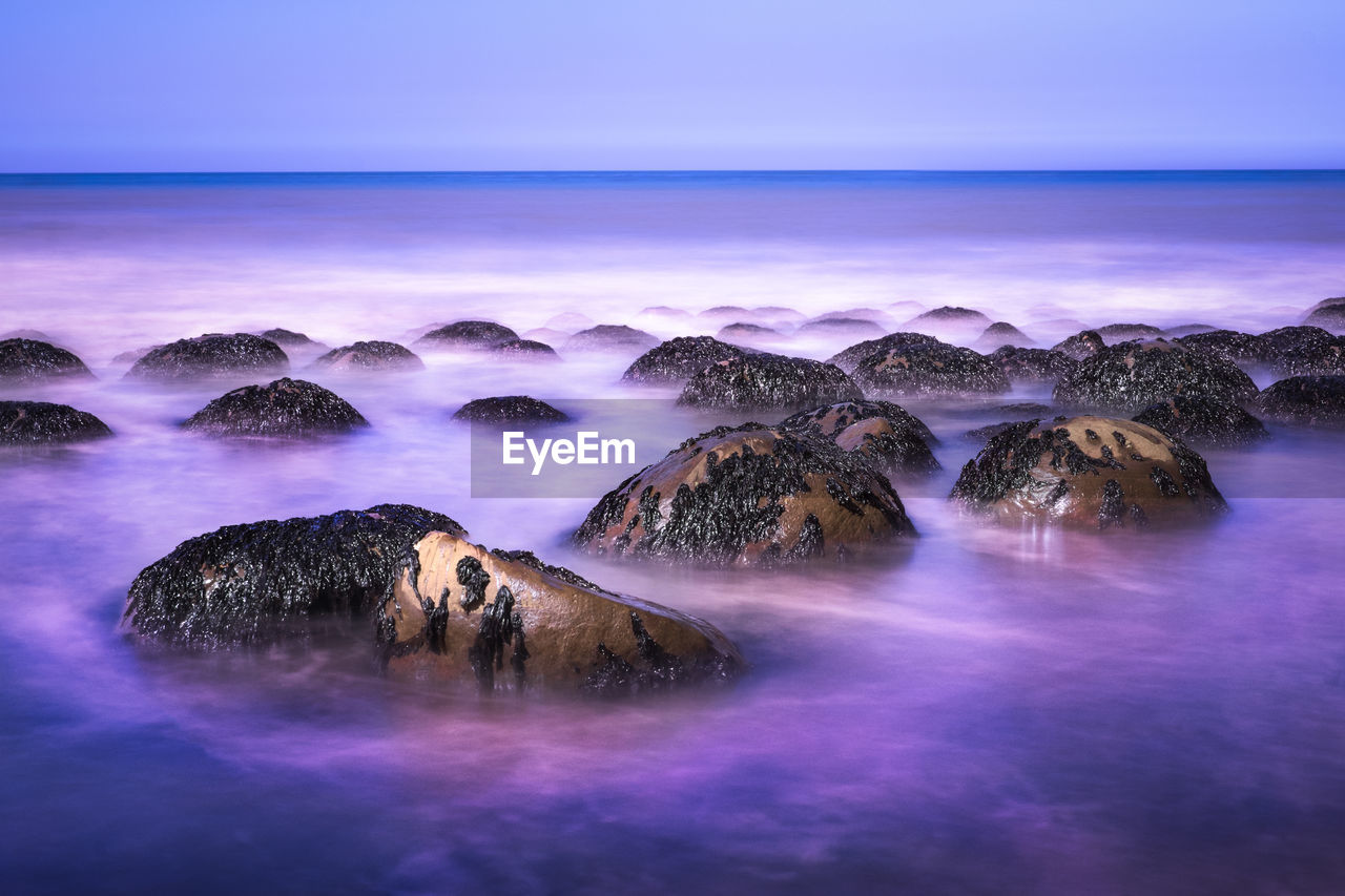 Scenic view of sea against sky at sunset