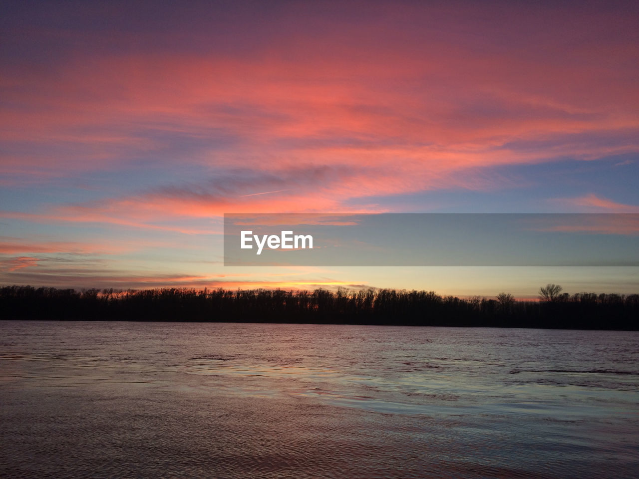 SILHOUETTE TREES BY LAKE AGAINST SKY DURING SUNSET