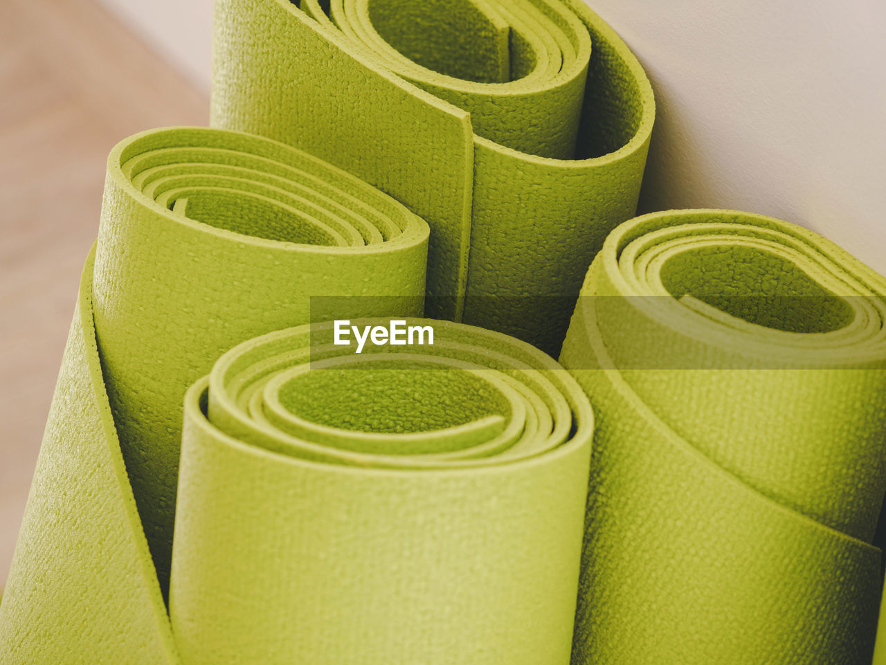 Close-up of green rolled exercise mats