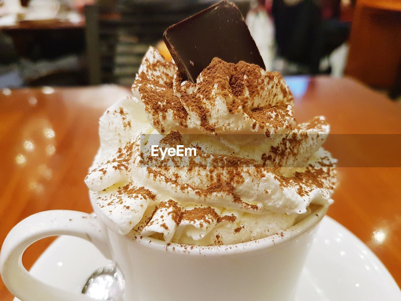 CLOSE-UP OF ICE CREAM ON TABLE