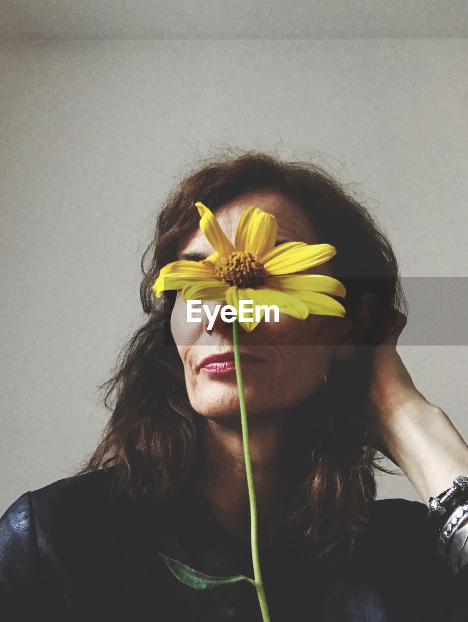 yellow, one person, portrait, adult, women, headshot, black, young adult, flower, hairstyle, flowering plant, long hair, indoors, front view, lifestyles, brown hair, glasses, clothing, leisure activity, close-up, nature, holding, music, person, wall - building feature, human face, plant, studio shot, photo shoot, female, black hair, fashion, listening