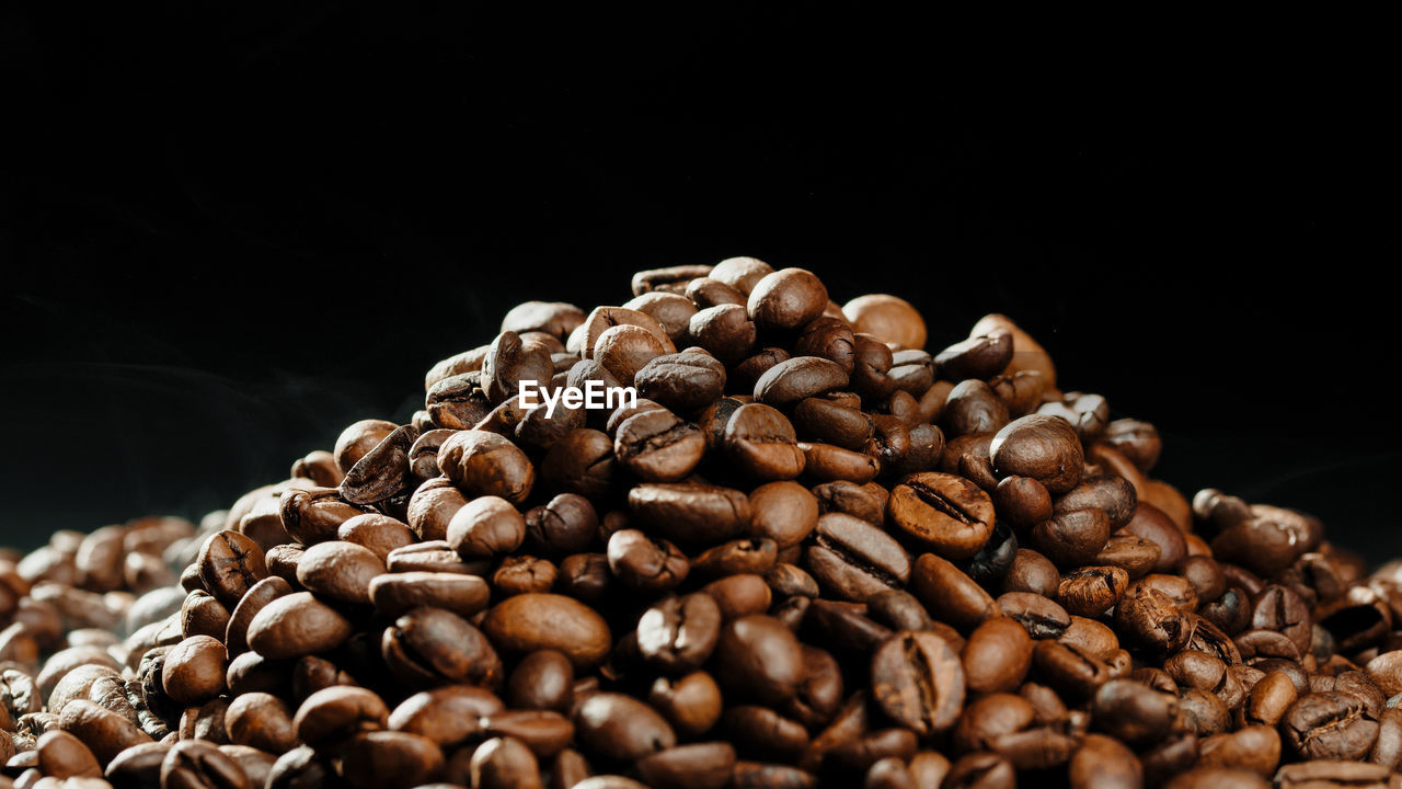 food and drink, food, coffee, roasted coffee bean, close-up, brown, black background, drink, freshness, large group of objects, copy space, dark, no people, abundance, still life, studio shot, indoors, roasted, cup, heap, nature, produce, coffee crop