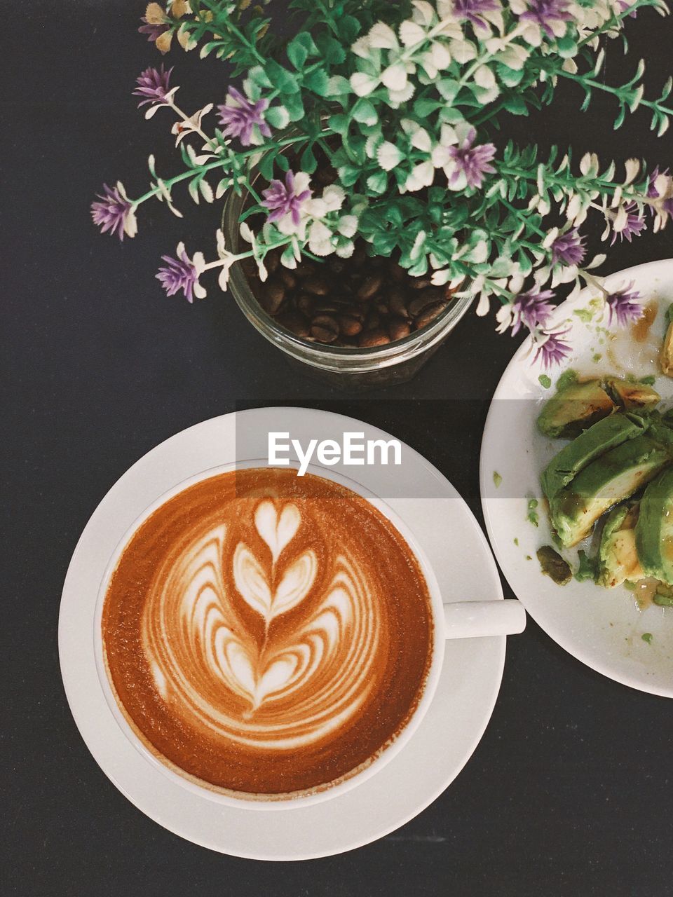 HIGH ANGLE VIEW OF CAPPUCCINO SERVED ON TABLE AT HOME