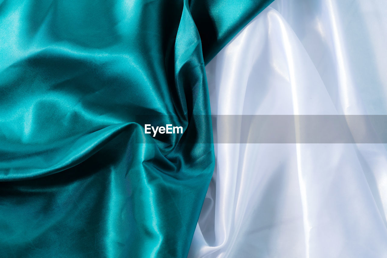 textile, blue, satin, rippled, backgrounds, silk, turquoise, full frame, crumpled, no people, azure, pattern, wrinkled, abstract, sheet, linen, aqua, bed, material, textured, indoors, green, curve, shiny, luxury, folded, smooth, wealth, wave pattern, curtain, softness, close-up, electric blue, elegance