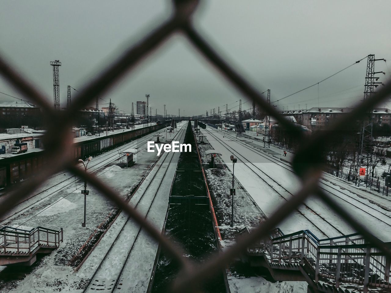 TRAIN ON RAILROAD TRACK AGAINST SKY