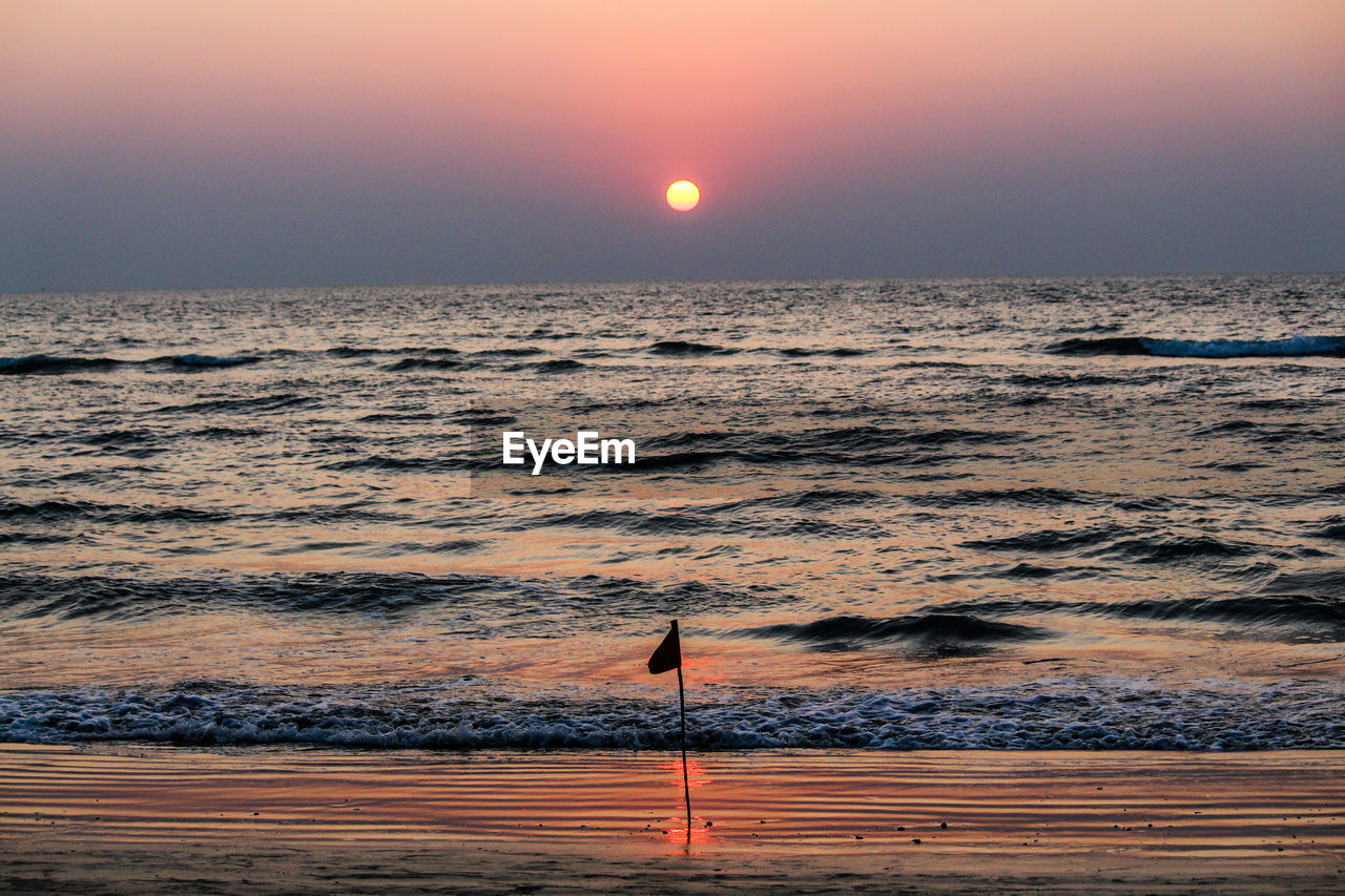 Scenic view of sea against clear sky during sunset