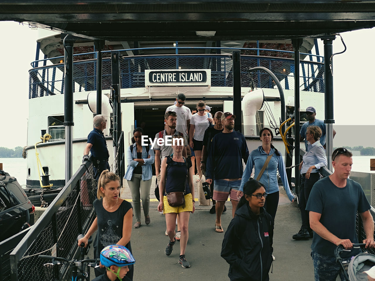 PEOPLE WAITING AT RAILROAD STATION PLATFORM