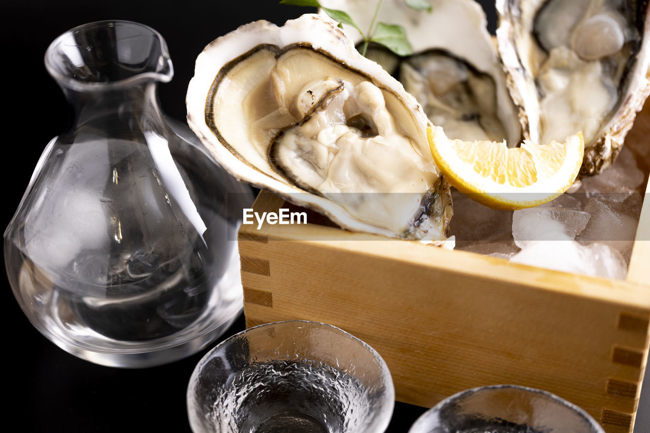 oyster, food and drink, food, seafood, shellfish, indoors, container, no people, freshness, still life, household equipment, glass, healthy eating, table, high angle view, animal, drinking glass, ingredient, drink, close-up