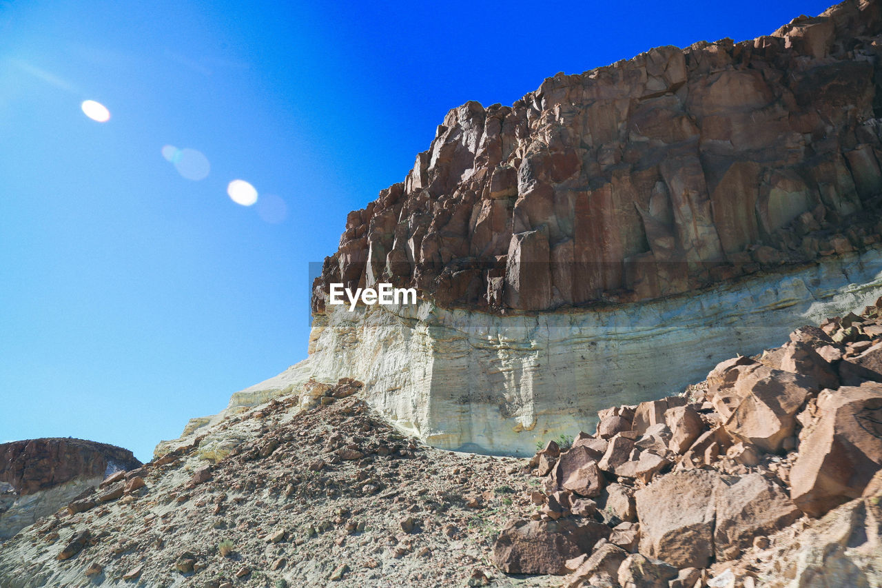 Scenic view of rocky mountains against clear blue sky