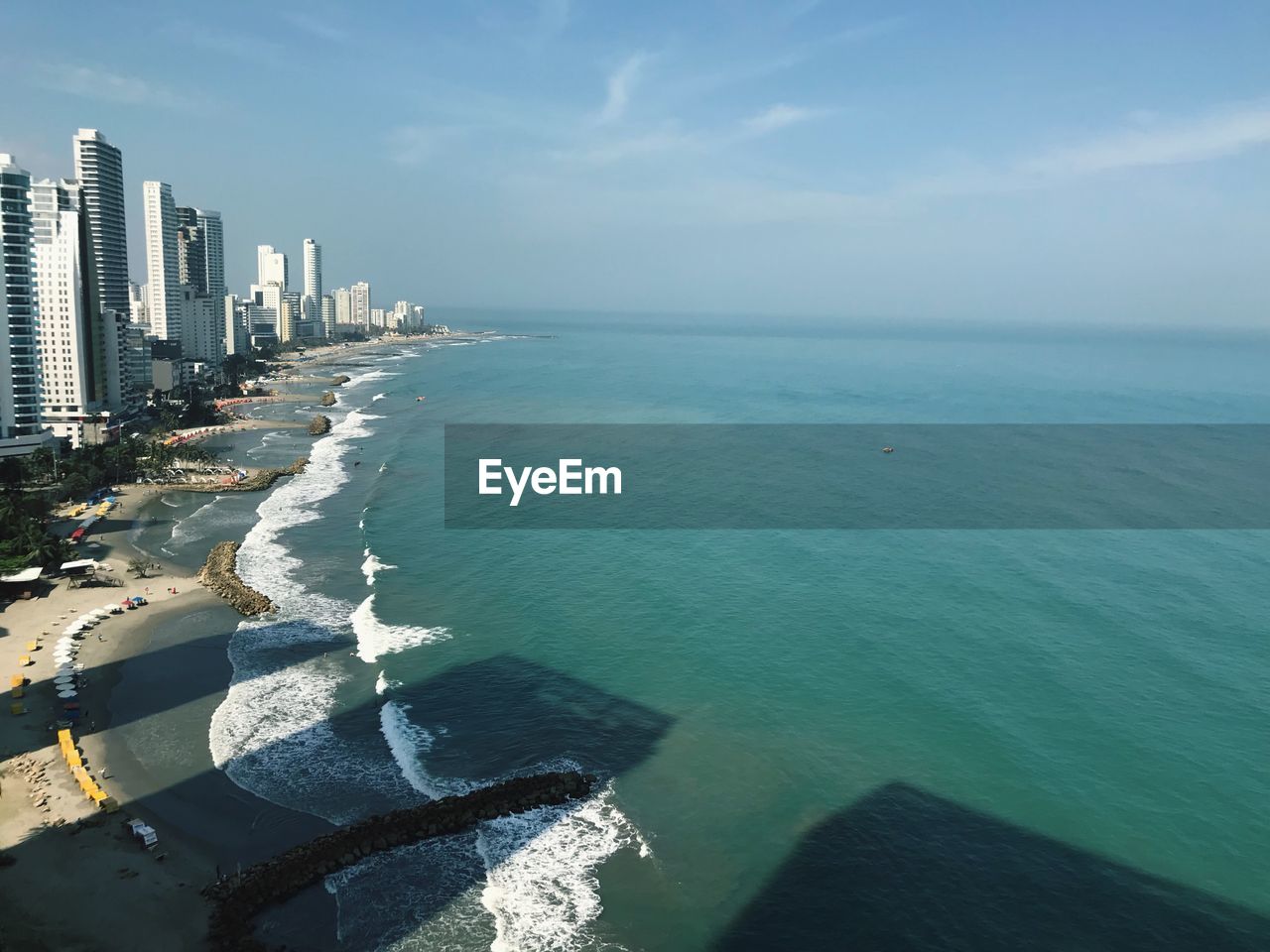 Scenic view of sea and buildings against sky