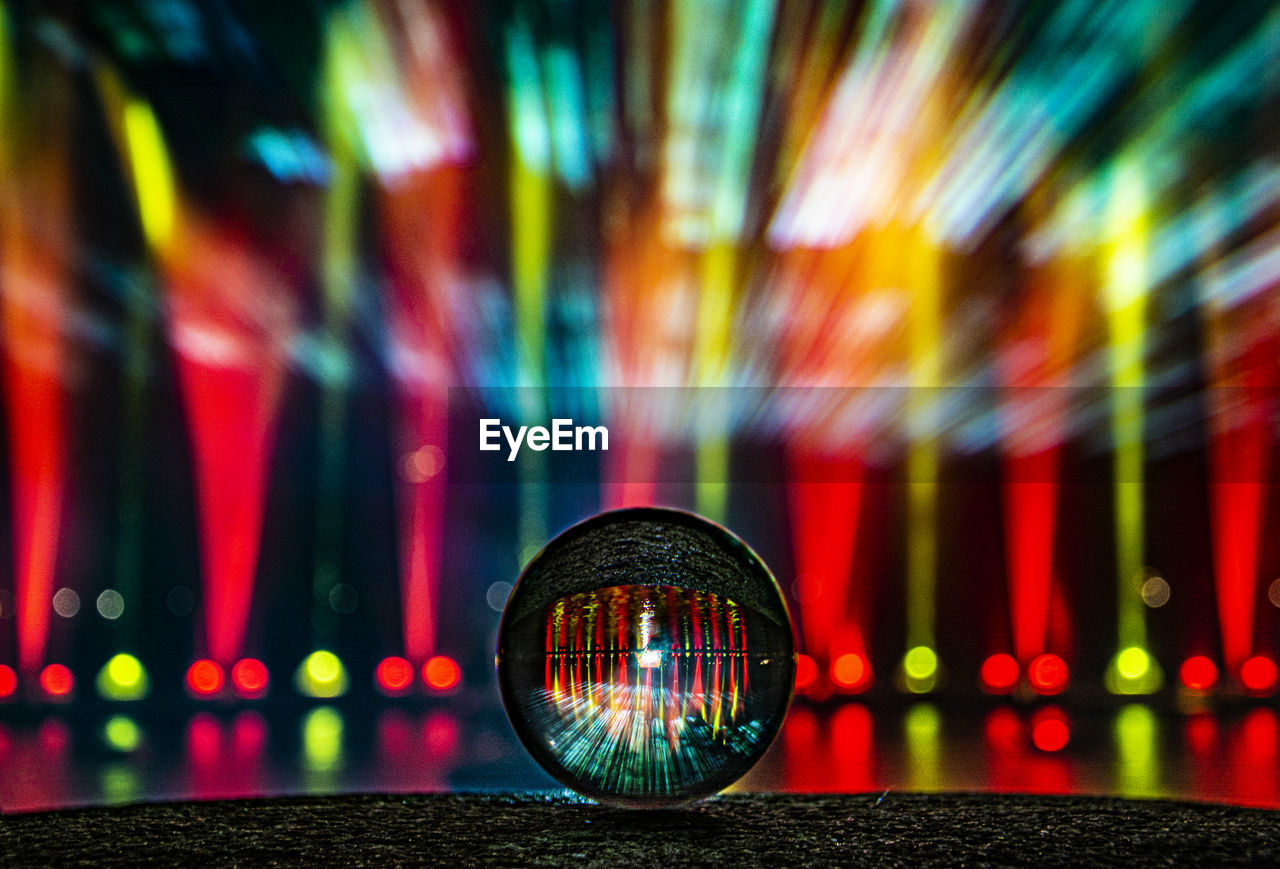 Close-up of illuminated lighting equipment on railing