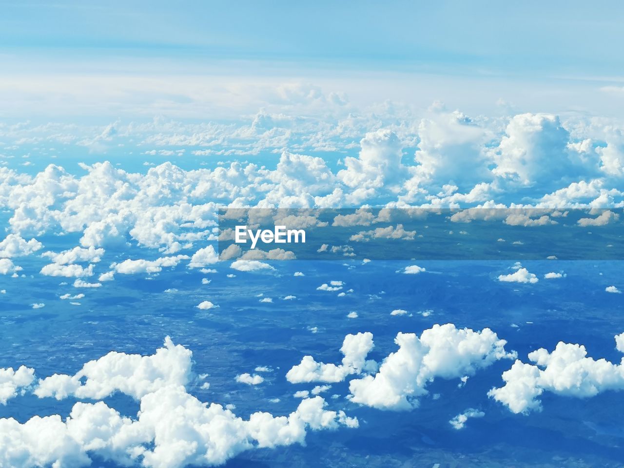 sky, cloud, environment, scenics - nature, beauty in nature, horizon, aerial view, nature, blue, landscape, cloudscape, snow, no people, idyllic, cold temperature, winter, tranquility, tranquil scene, white, airplane, mountain range, day, travel, plain, outdoors, air vehicle, water, ice, high angle view, flying, atmosphere, ice cap, backgrounds, land