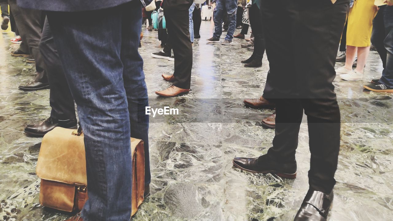 LOW SECTION OF PEOPLE STANDING ON STREET BY WATER