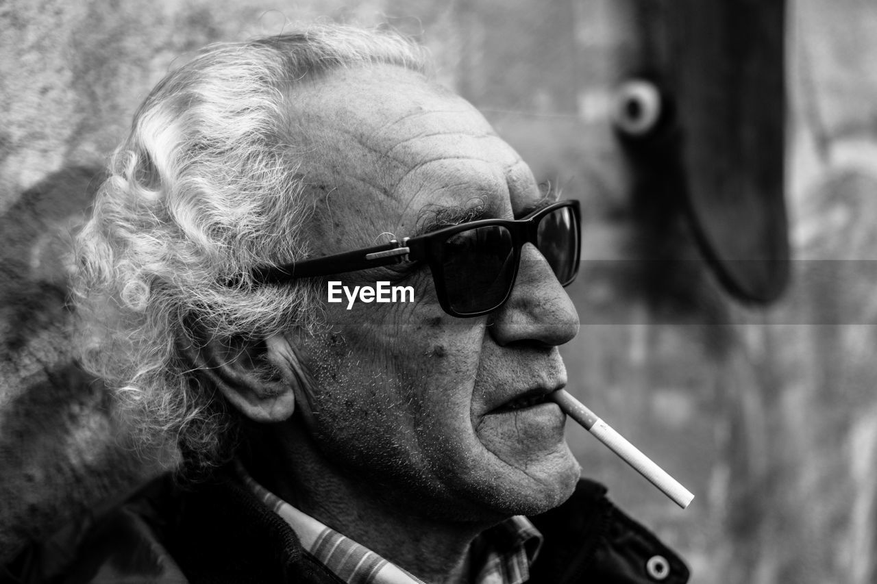 Close-up of mature man smoking cigarette