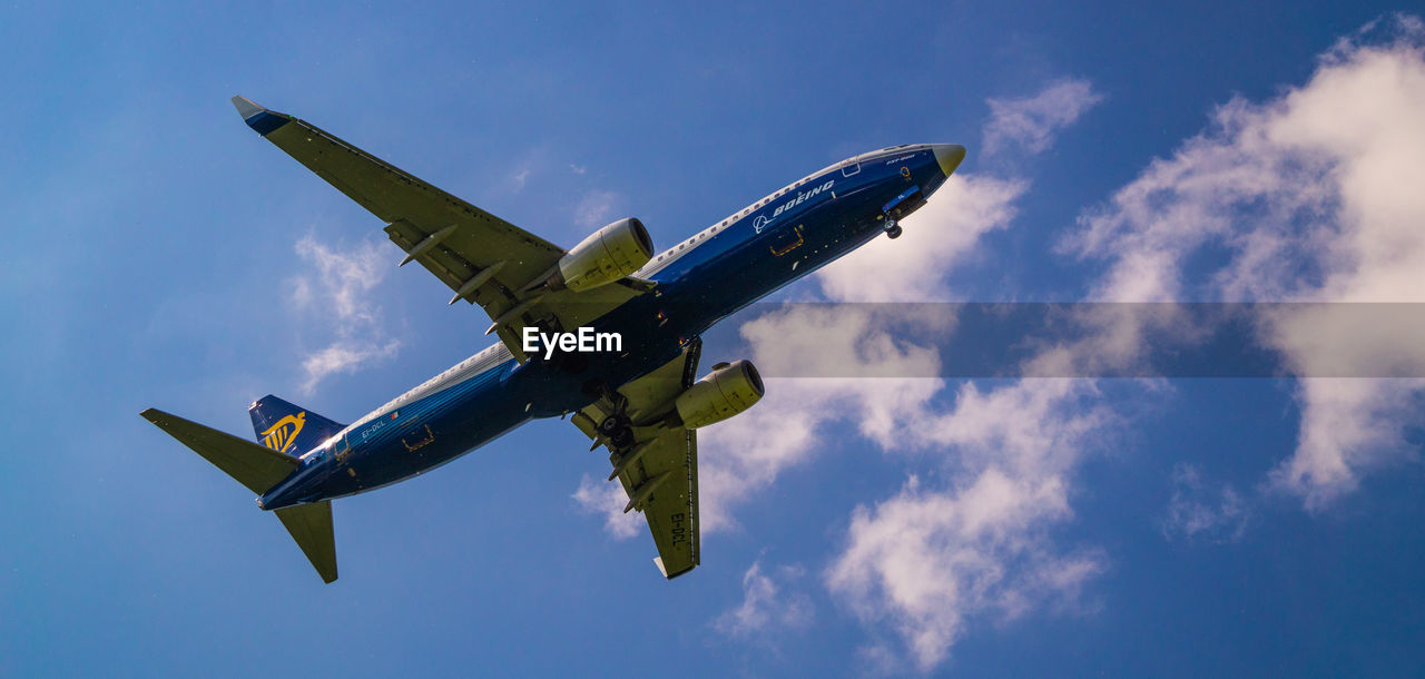 LOW ANGLE VIEW OF AIRPLANE IN SKY