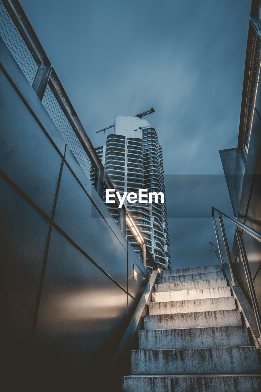 Low angle view of staircase by building against sky