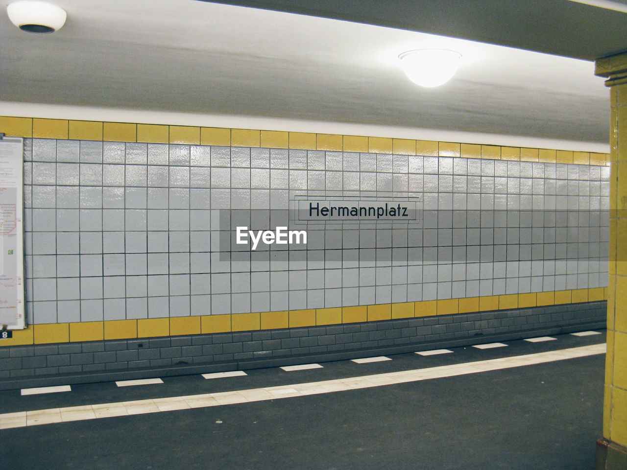 Illuminated light on ceiling at subway station