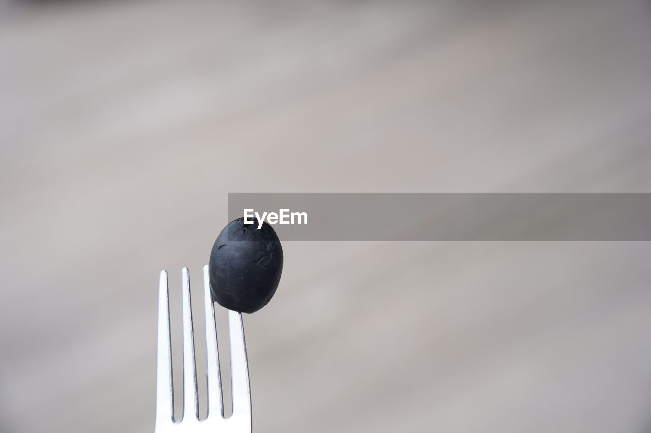 Black olive on fork