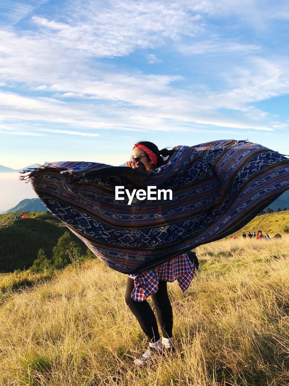 Full length of woman with scarf standing on field