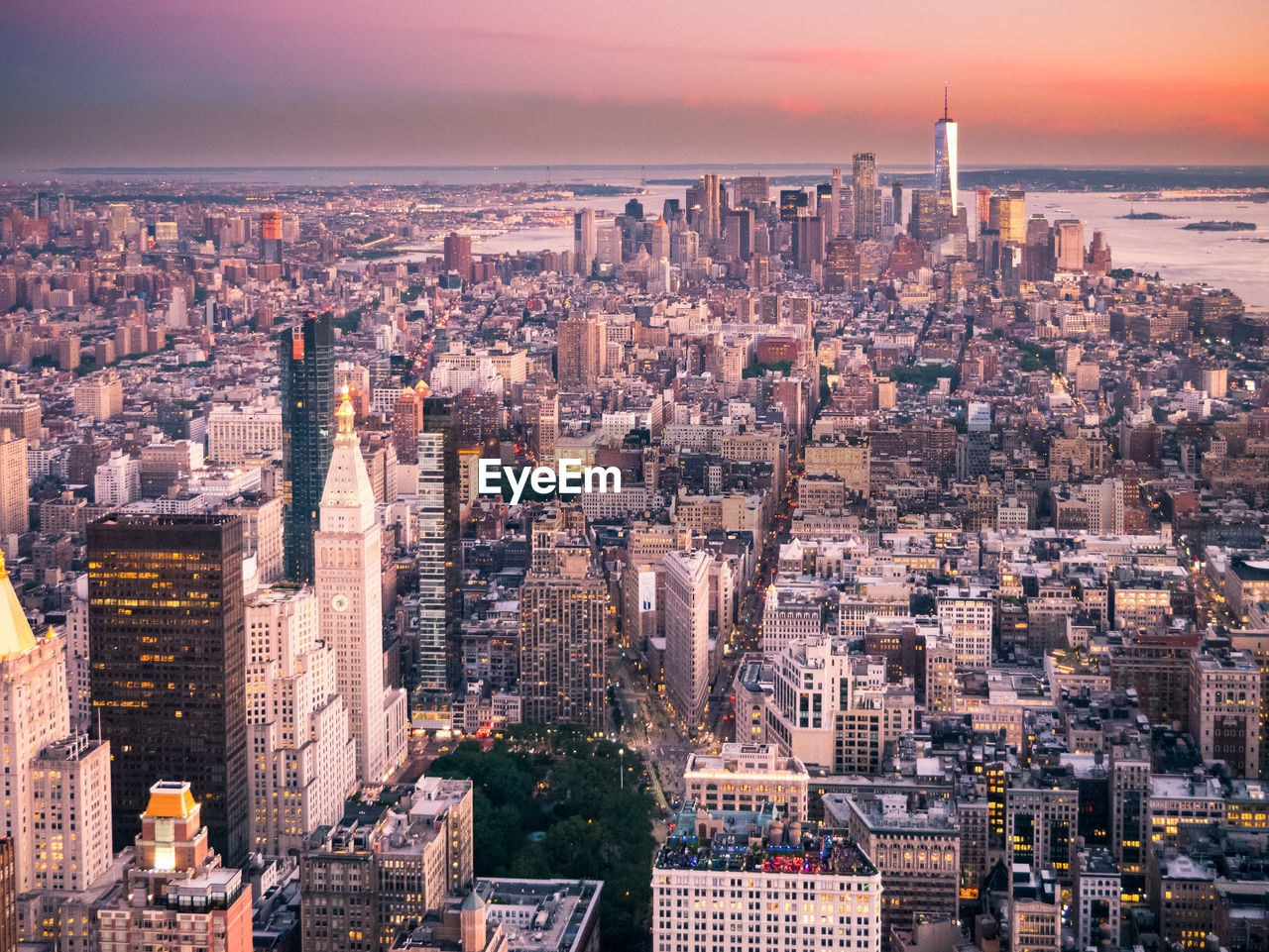 Aerial view of buildings in city during sunset