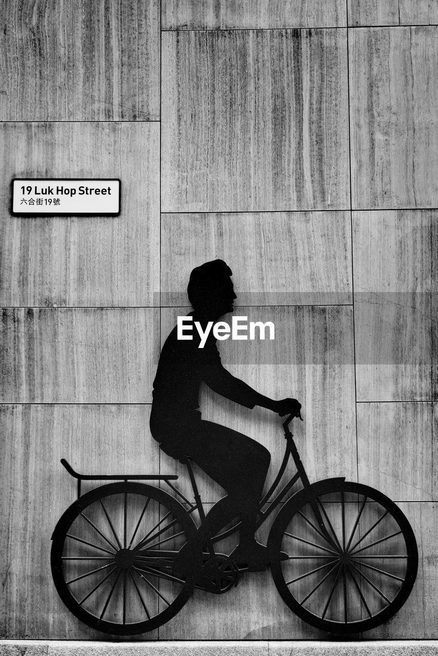 SIDE VIEW OF MAN RIDING BICYCLE