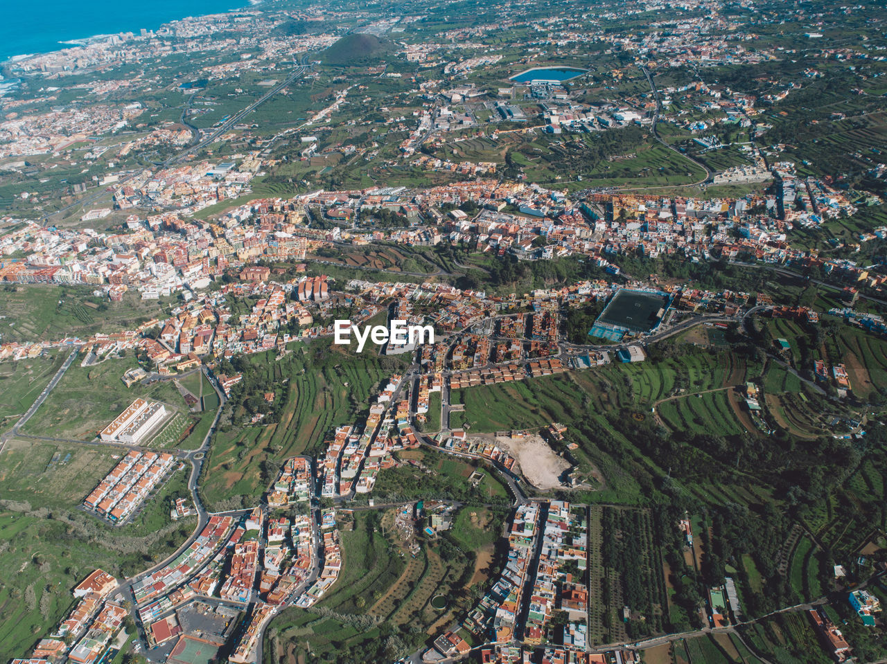 High angle view of trees and buildings in city