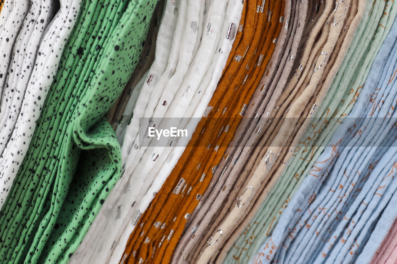 Detailed close up view on samples of cloth and fabrics in different colors found at a fabrics market